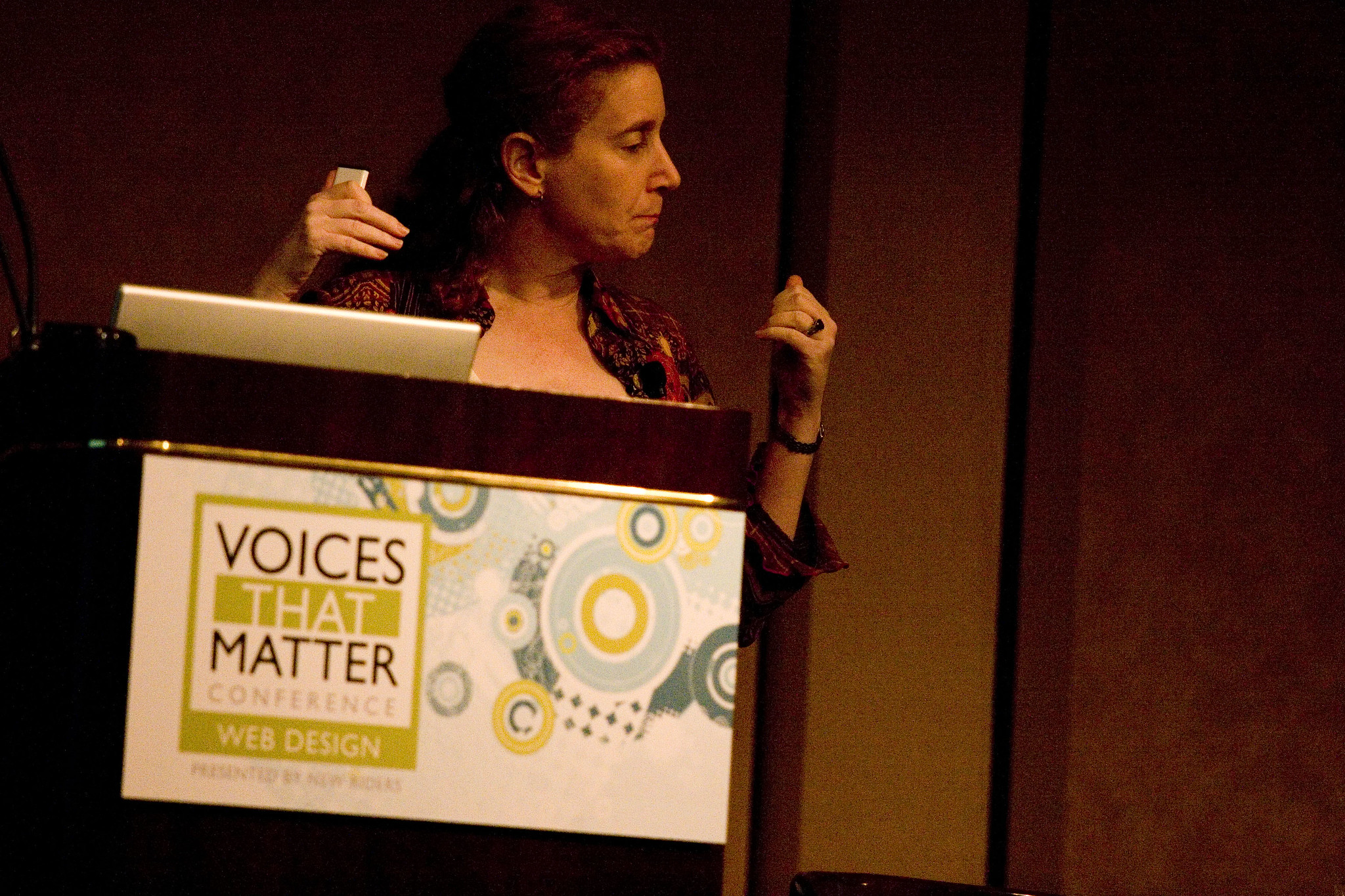 A speaker on stage behind a podium